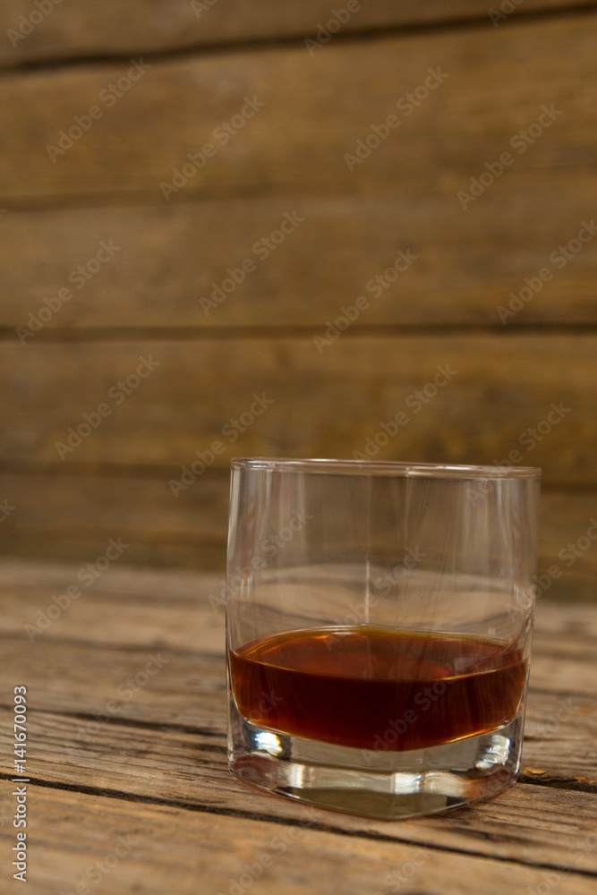 Glass of whisky on wooden table Glass of whisky on wooden table