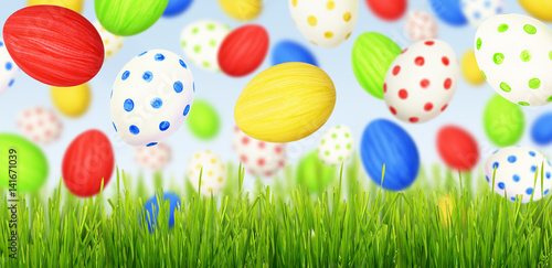 Cololrful Easter eggs falling at green grass © Ortis