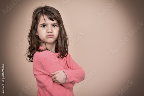 Photography Angry and pouting cute young girl with crossed arms