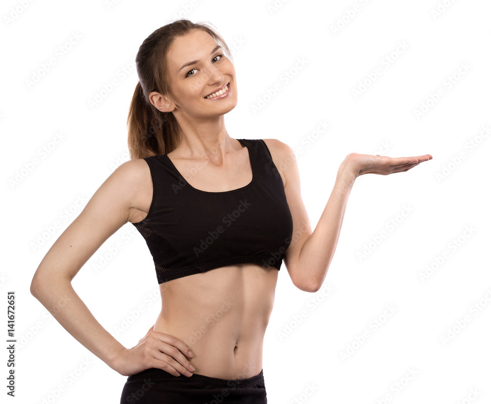 Healthy sporty woman shows something with smile Healthy sporty woman shows something with smile