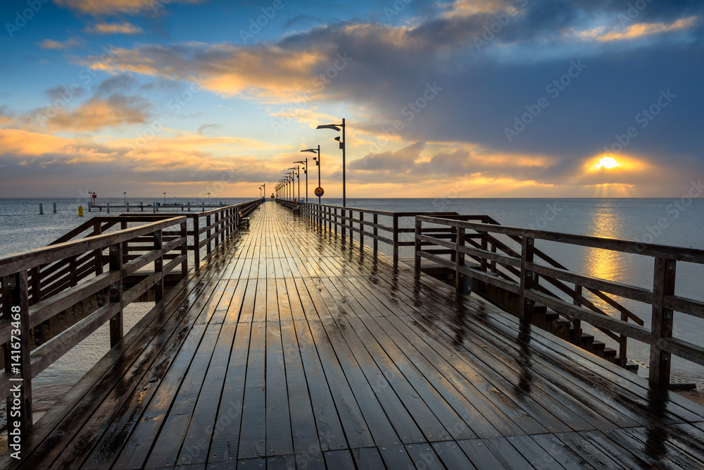 Wooden pier in Mechelinki fishing village. Rainy morning on the shore of Baltic Sea. Poland, Europe.
