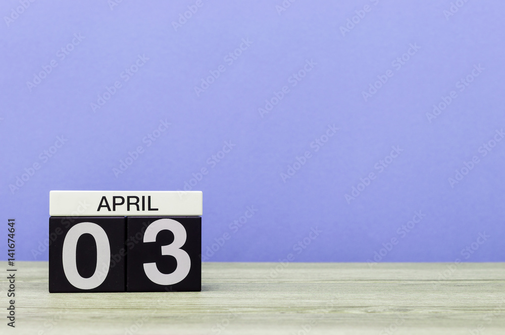 April 3rd. Day 3 of month, calendar on wooden table and purple background. Spring time, empty space for text April 3rd. Day 3 of month, calendar on wooden table and purple background. Spring time, empty space for text