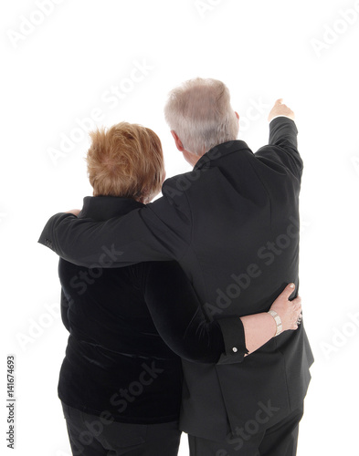 Senior couple standing from back.