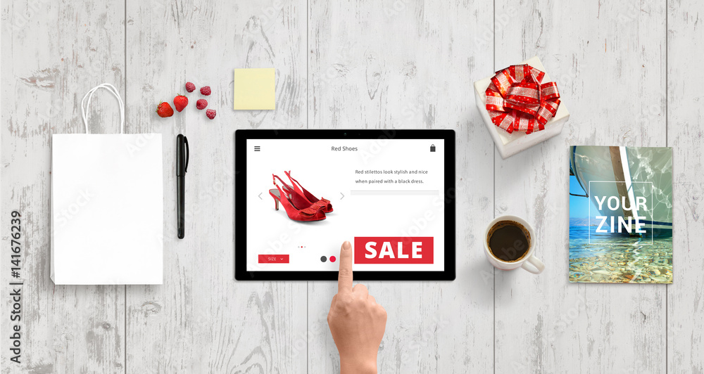 Woman buy shoes with tablet on online market web site. Shopping bag, gift  box, magazine, coffee, note, pencil, strawberries and raspberries beside.  Top view of white wooden desk. Stock Photo | Adobe