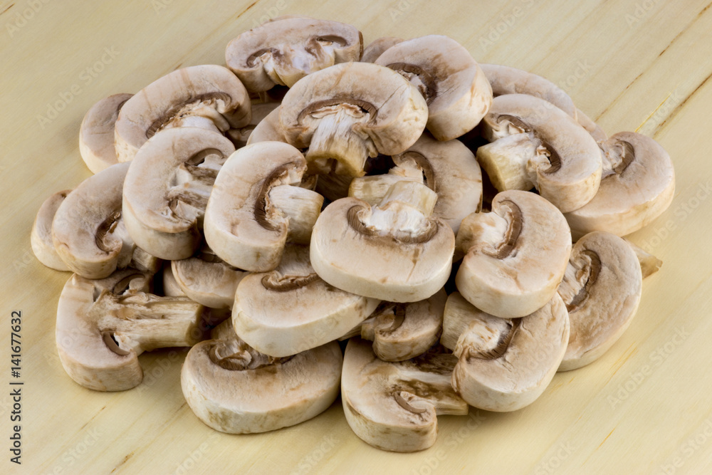 Small Mushrooms Sliced on a Wooden Table Small Mushrooms Sliced on a Wooden Table