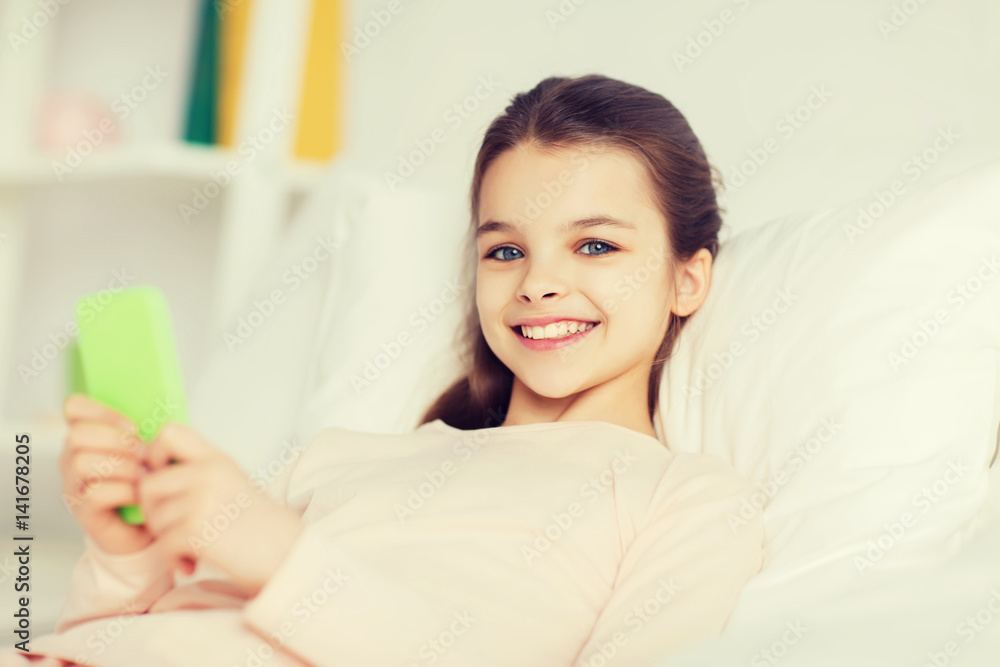 happy girl lying in bed with smartphone at home happy girl lying in bed with smartphone at home