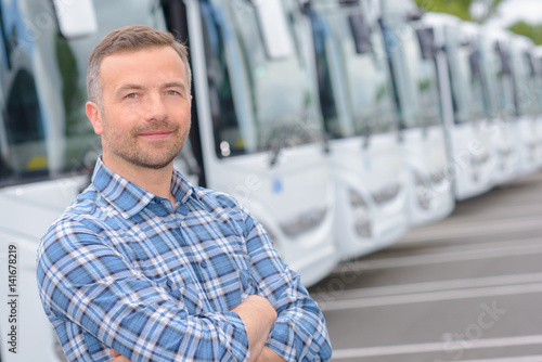 Vászonkép Portrait of man with fleet of buses