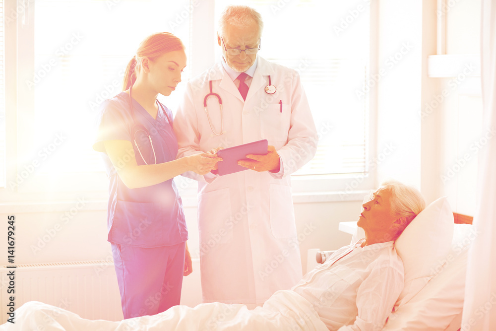 Fototapeta premium doctor and nurse visiting senior woman at hospital