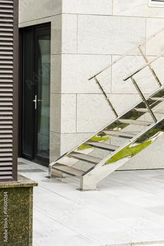 wall with granite floors and walls with a chrome ladder