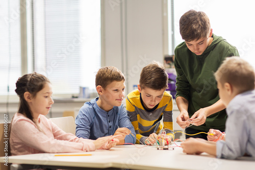 happy children building robots at robotics school