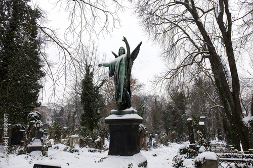 Winter snowy mystery old Prague Cemetery Olsany with its Statues, Czech Republic