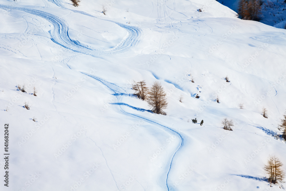 Skiers curves on the snowcapped mountains slopes