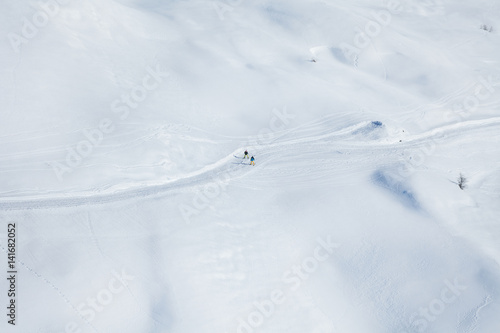 Two skiers running on the snowcapped mountains