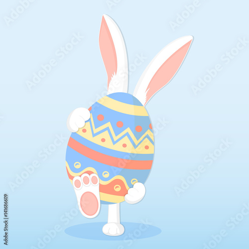 Easter bunny holding a big paschal egg
