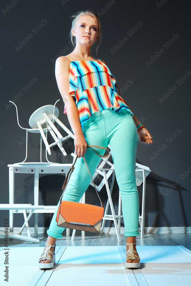 Φωτογραφία Beautiful fashion girl with furniture details on dark background