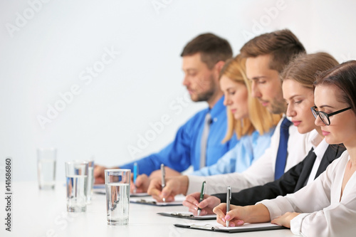 Human resources team sitting in a row at table in office photo