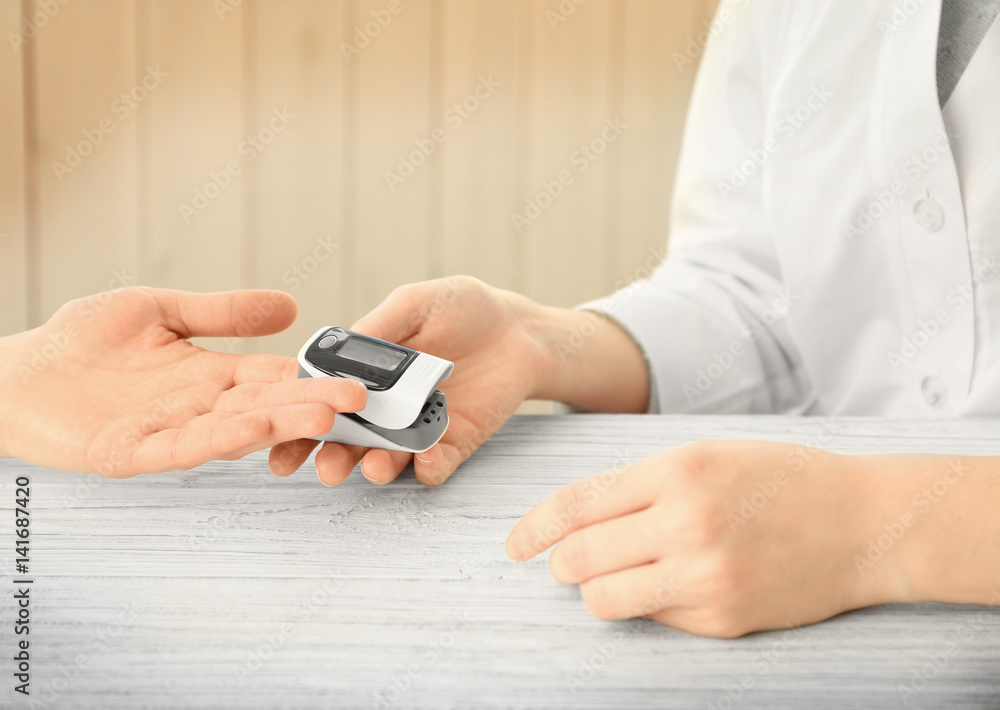 Closeup view of doctor examining woman with heart rate monitor Closeup view of doctor examining woman with heart rate monitor