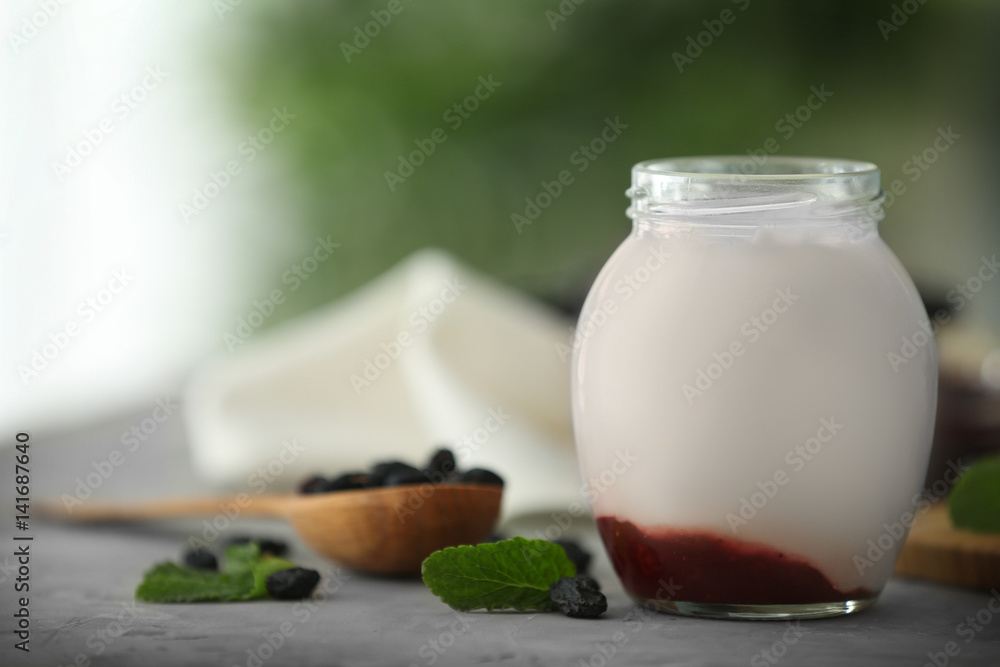 Glass jar with delicious yogurt on table Glass jar with delicious yogurt on table