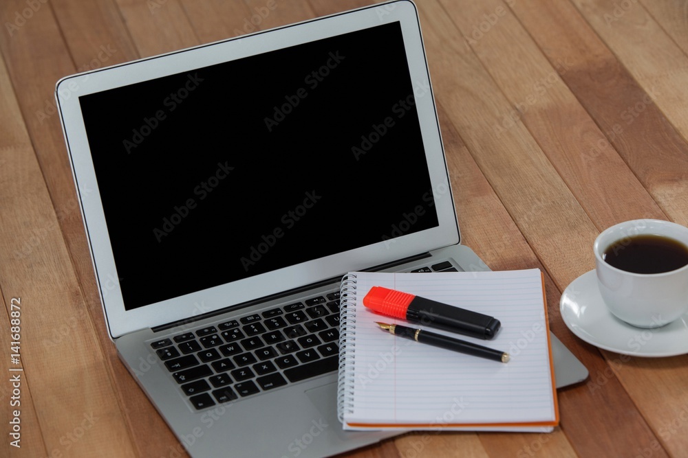 Cup of coffee with laptop, organizer, maker and pen Cup of coffee with laptop, organizer, maker and pen