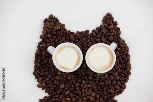 Coffee beans and cups forming owl