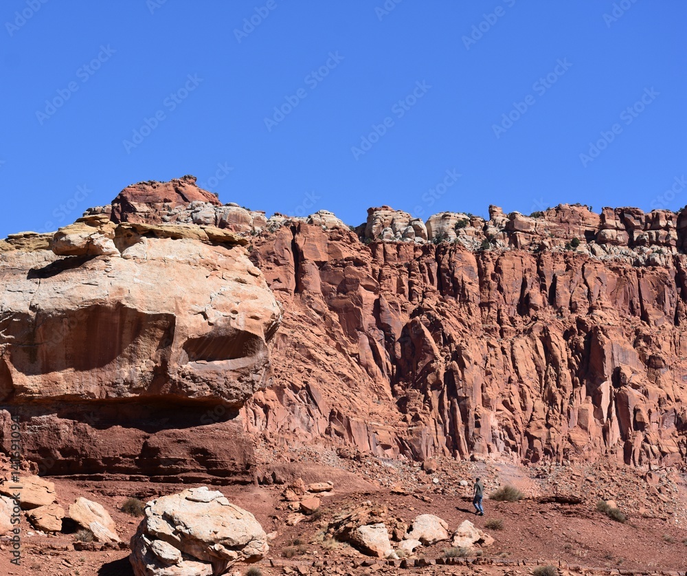Fototapeta premium Man hiking near rocks in Capitol Reef Park, Utah.