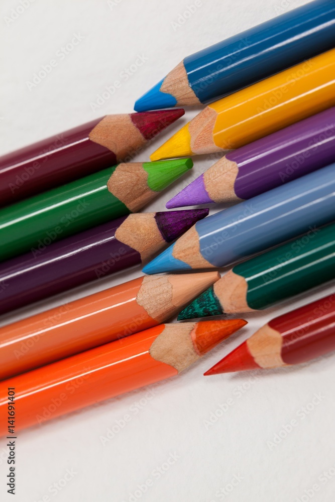 Fototapeta premium Colored pencils arranged in interlock pattern 