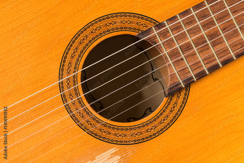 Close up on a classic guitar made of wood Close up on a classic guitar made of wood