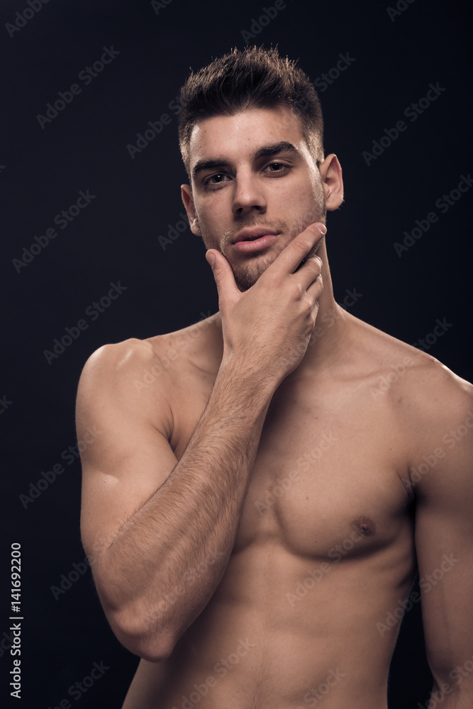 Fototapeta premium one young man, handsome, looking at camera, shirtless hand face