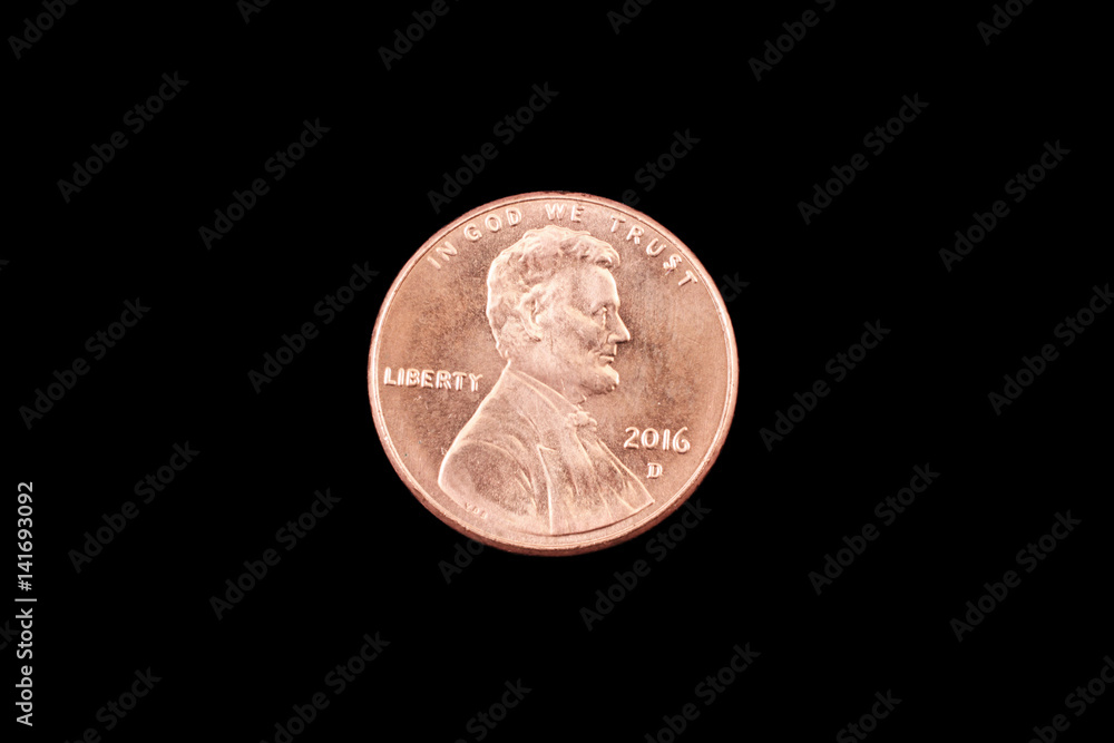A close up image of an American one cent coin on a black background A close up image of an American one cent coin on a black background