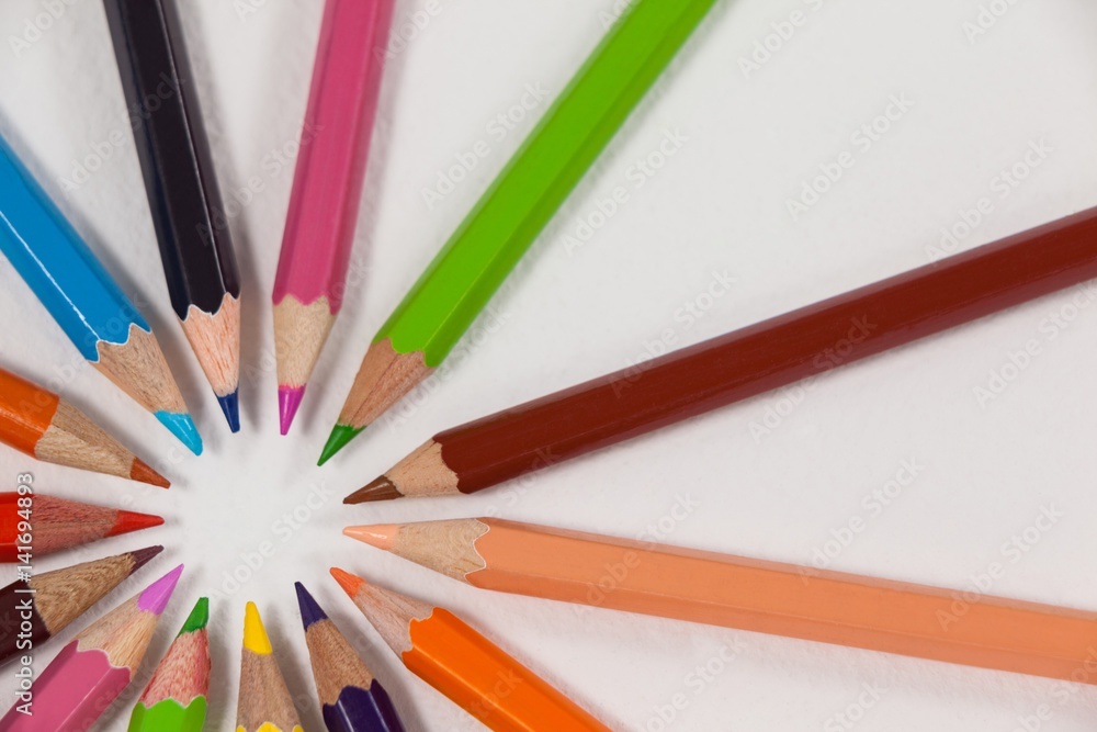 Close-up of colored pencils arranged in a circle