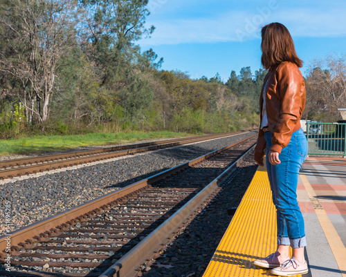 Girl Standing Near Train Rails photo