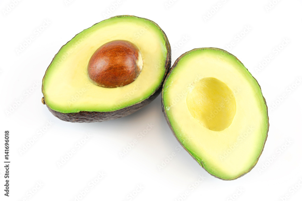 fresh cut avocado in halves isolated on white background