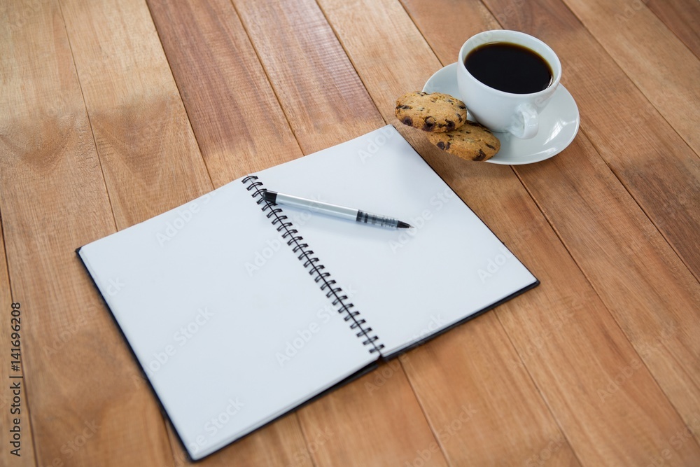 Open diary with pen and black coffee Open diary with pen and black coffee