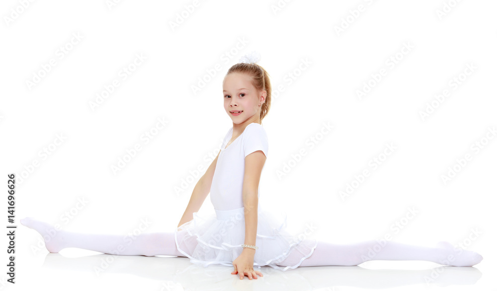 Little girl performs gymnastic exercise, the splits. Little girl performs gymnastic exercise, the splits.