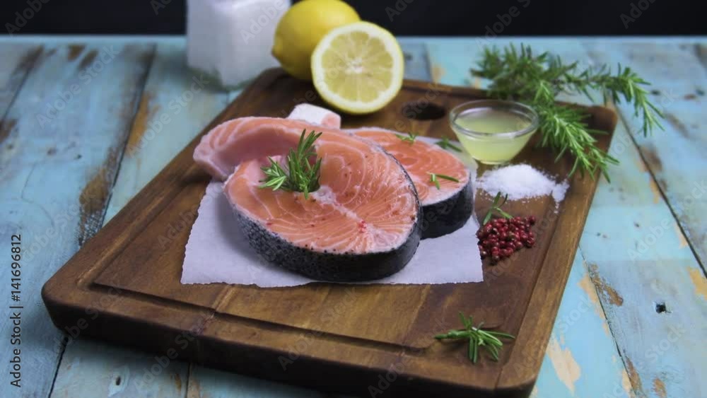 Fresh fish. Salmon. Raw salmon steak with sea salt pepper and herbs. Food background. Fresh fish. Salmon. Raw salmon steak with sea salt pepper and herbs. Food background.