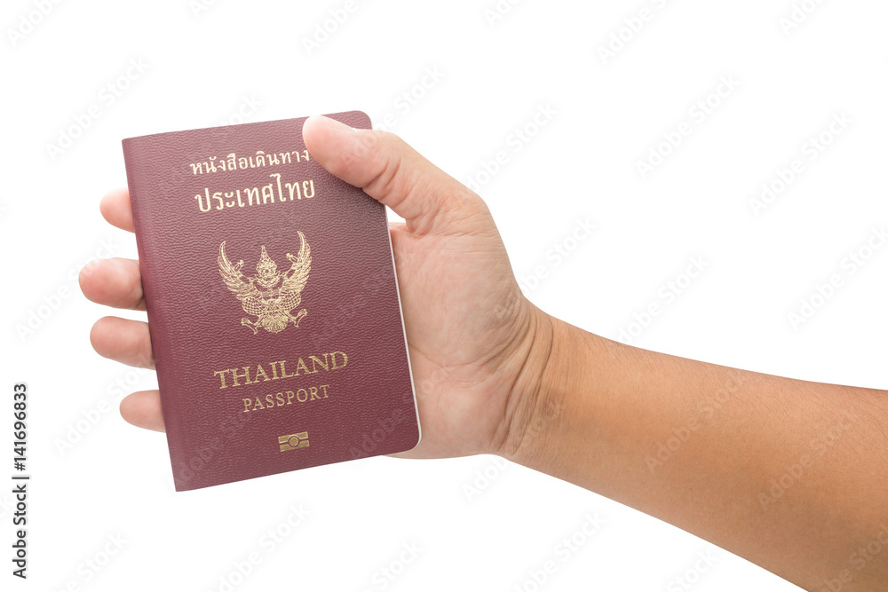 Male hand holding Thailand passport isolated on white background Male hand holding Thailand passport isolated on white background