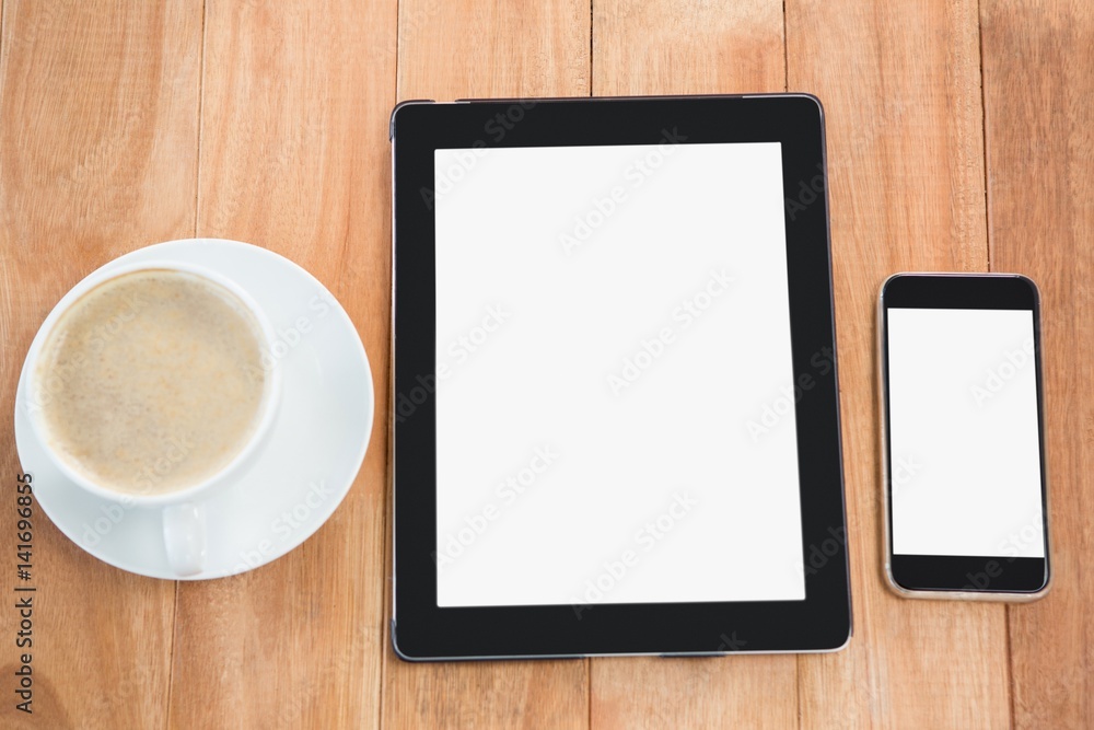 Cup of coffee with digital table and mobile phone Cup of coffee with digital table and mobile phone