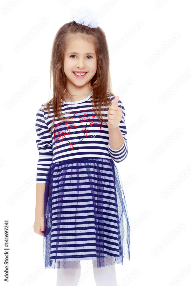 Cute little girl posing in front of the camera. Cute little girl posing in front of the camera.