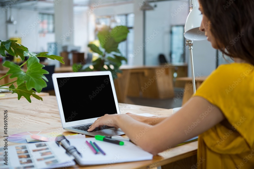 Female graphic designer using laptop Female graphic designer using laptop