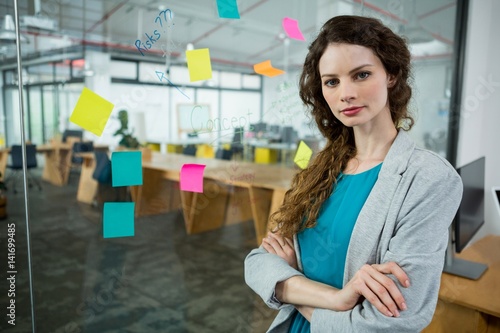 Female executive standing with arms crossed 