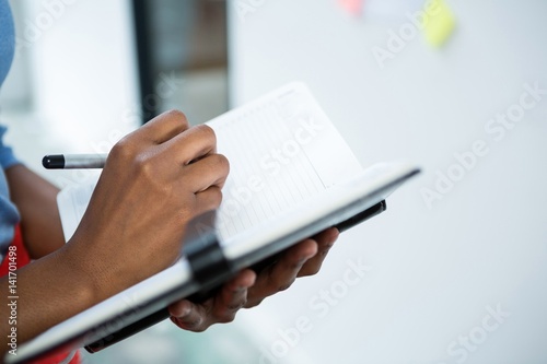 Female graphic designers taking down notes in a dairy