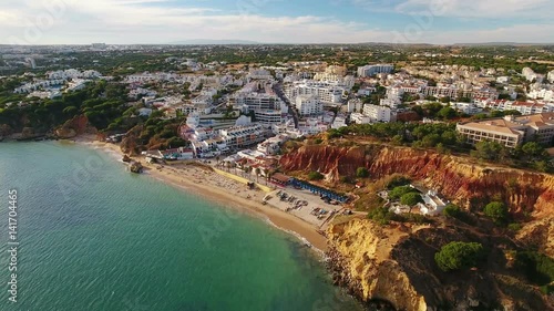 Aerial. View of town Olhos de Agua and a fishing beach from sky.