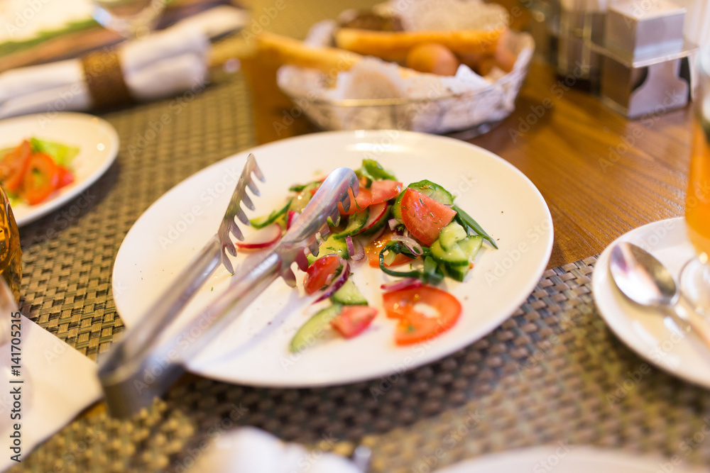 Dish with tomatoes and cucumbers in a restaurant Dish with tomatoes and cucumbers in a restaurant