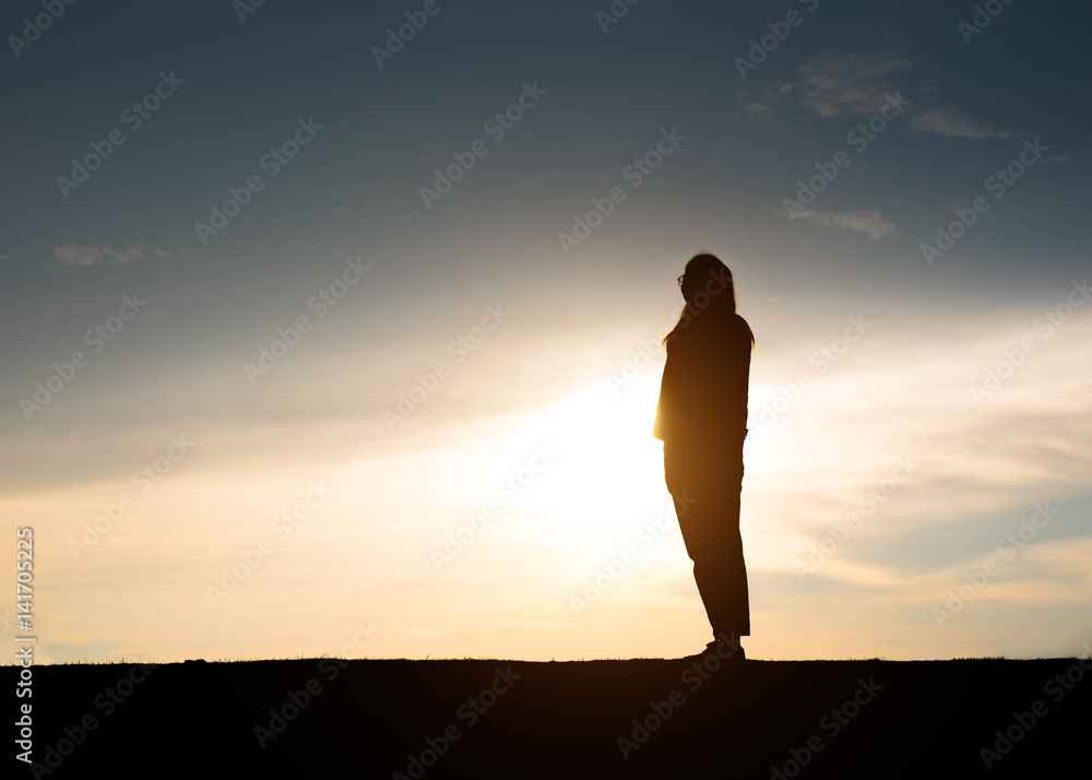 silhouette woman in front of a sunset