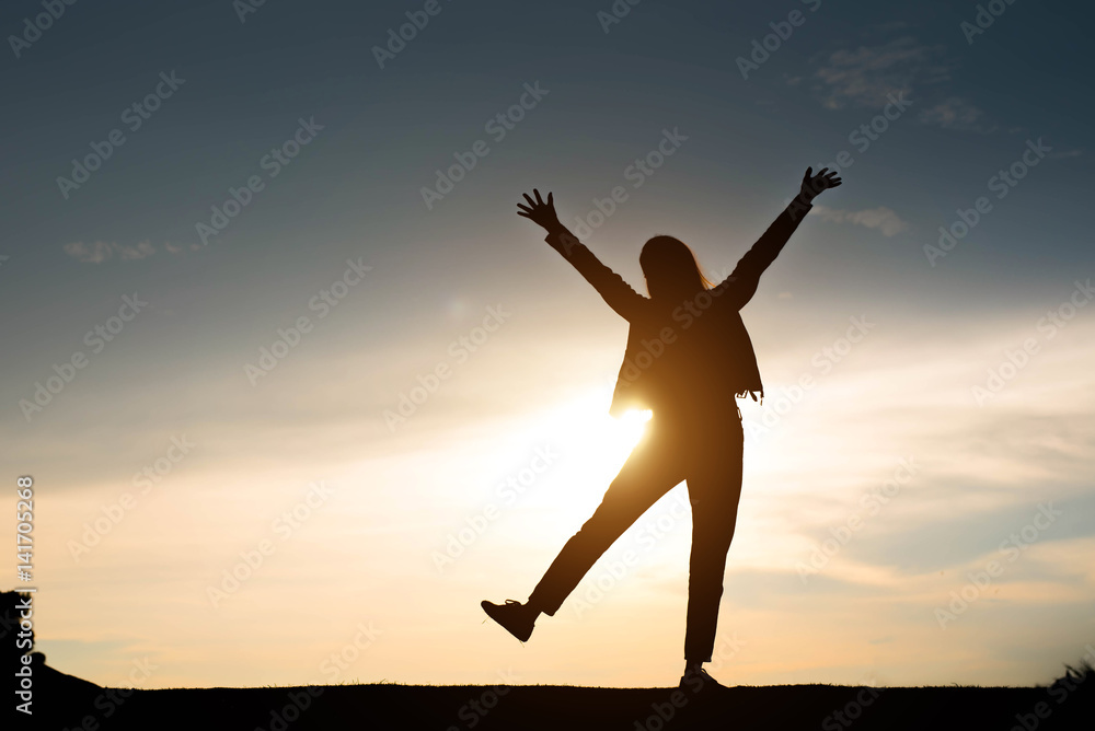 woman silhouette standing raise hand on sunset woman silhouette standing raise hand on sunset
