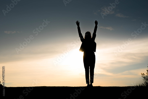 Silhouette woman happy at sunset