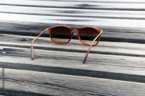 Sunglasses on wooden floor, Travel concept.