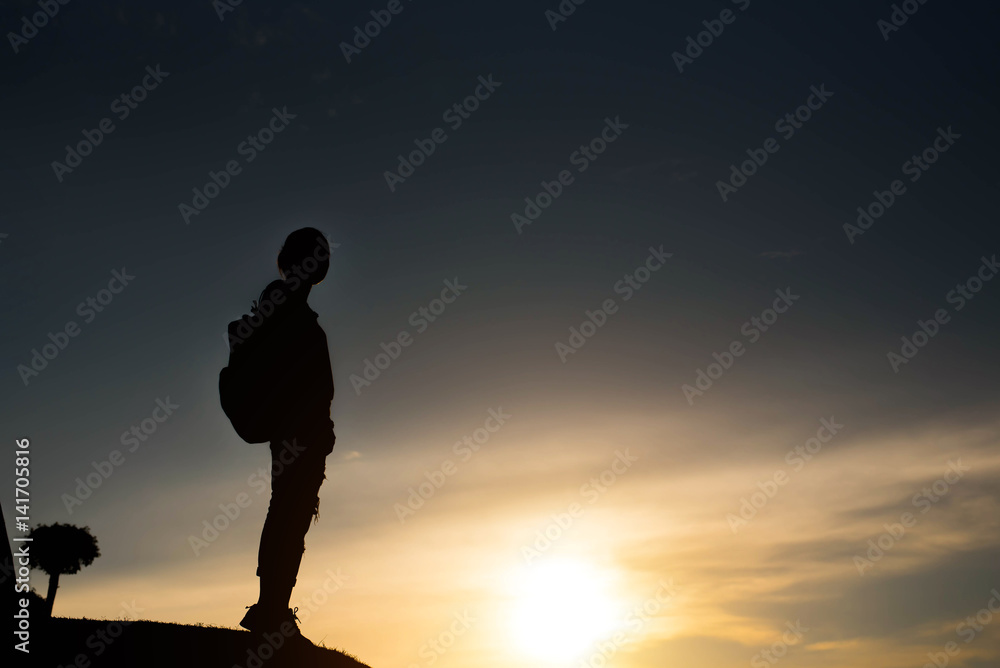 silhouette woman in front of a sunset