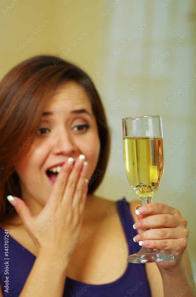 Beautiful girl holding glass with ring inside Beautiful girl holding glass with ring inside