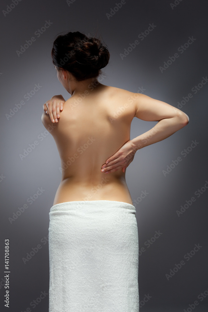 Woman massaging back pain Woman massaging back pain